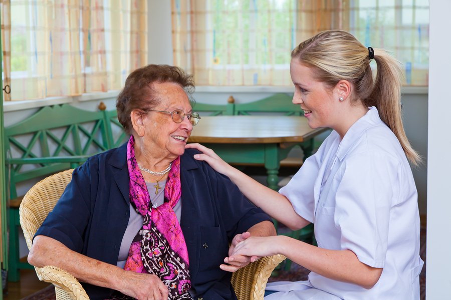 Care home nurse with elderly patient
